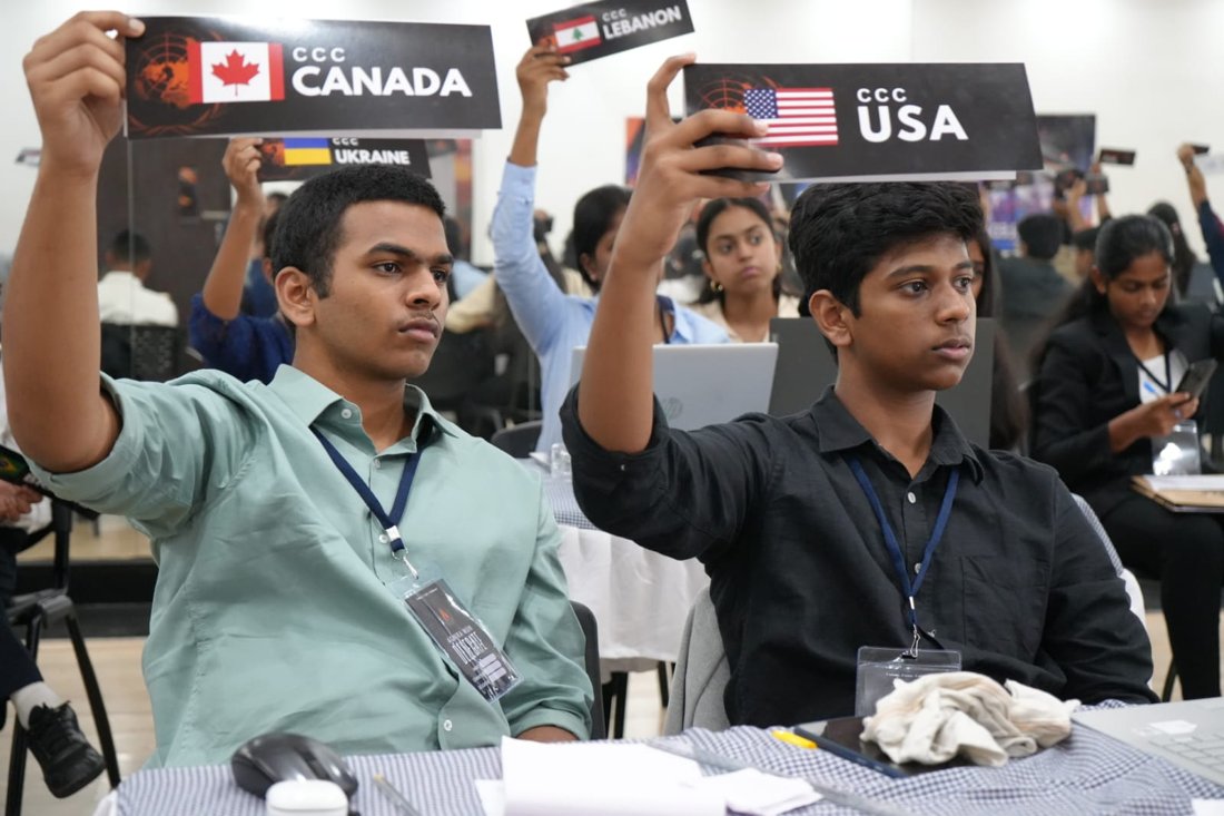 Delegates raising country placards in crisis committee